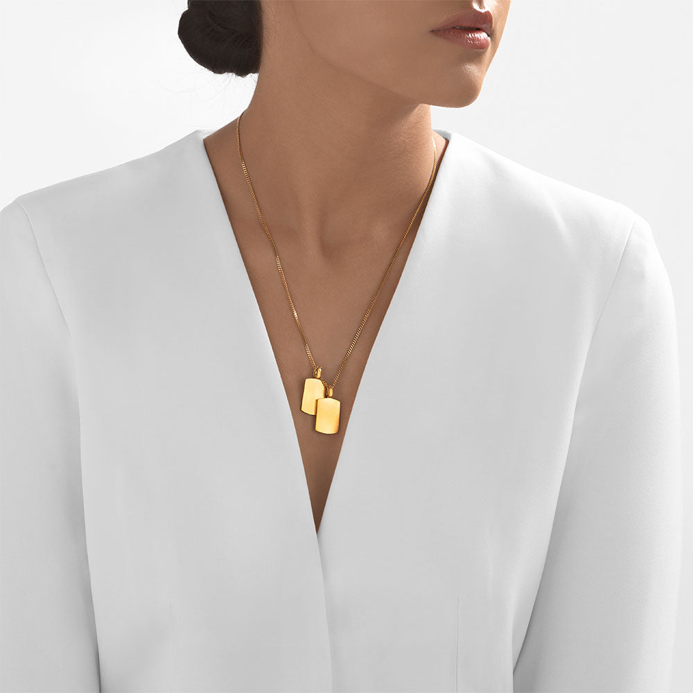 Double dog tag gold pendant close-up